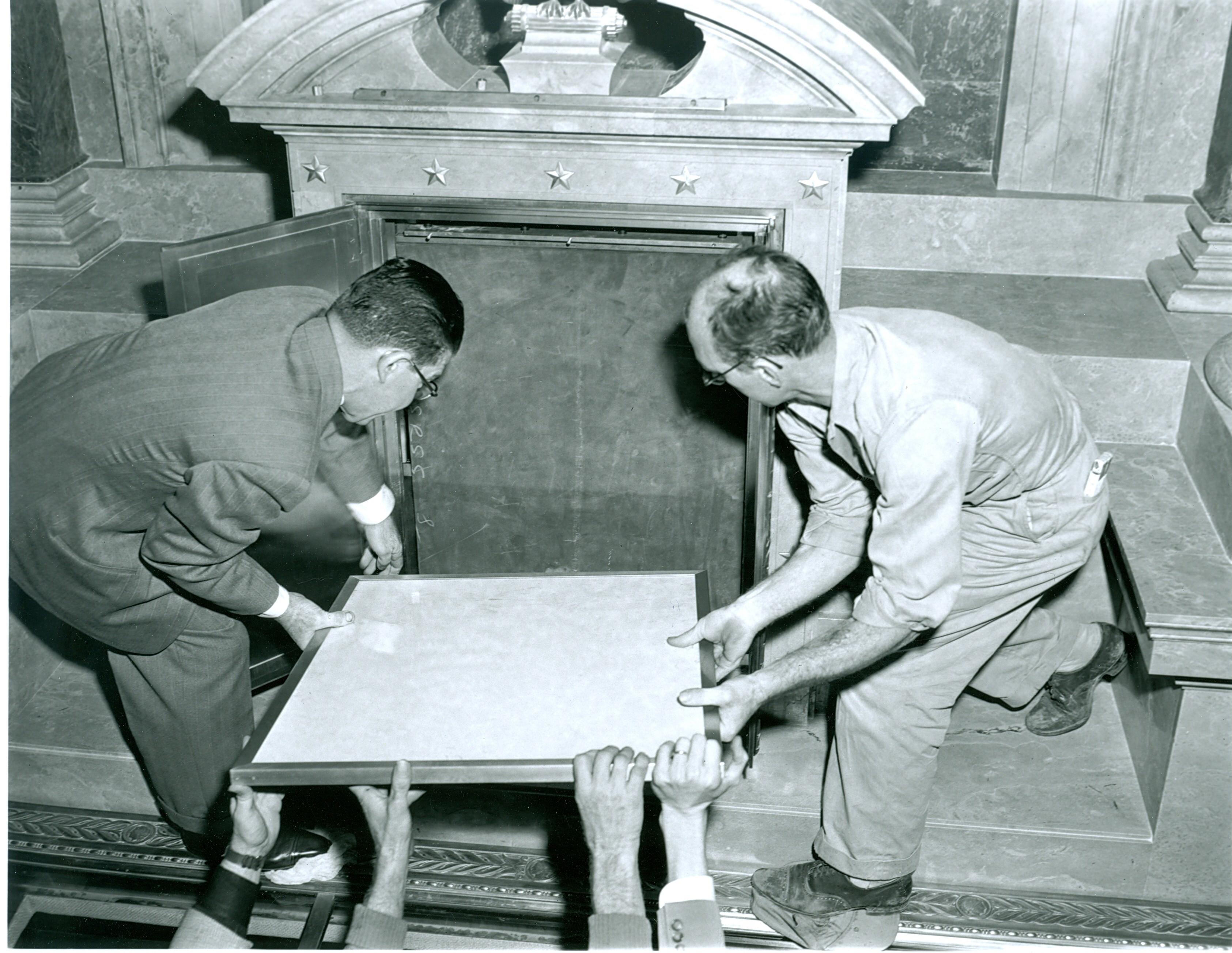 Two men placing the Declaration of Independence into the new display case at the National Archives (Source: National Archives) Two men placing the Declaration of Independence into the new display case at the National Archives (Source: National Archives)