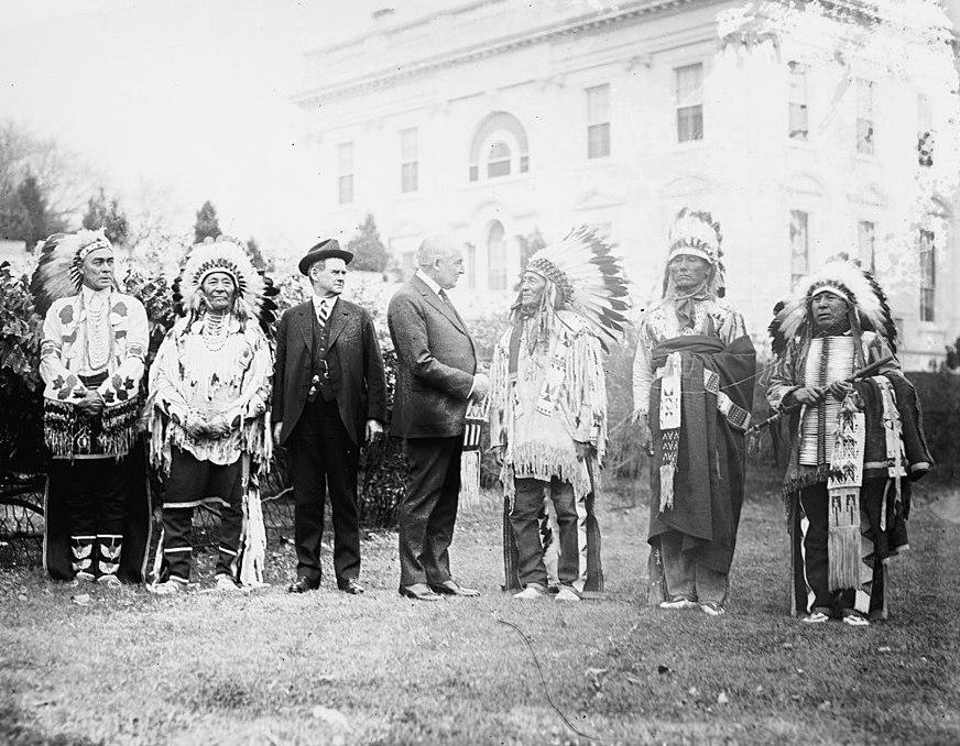 President Harding shaking hands with Native American Chiefs on the White House lawn. President Harding with five Native American Chiefs on the White House Lawn.