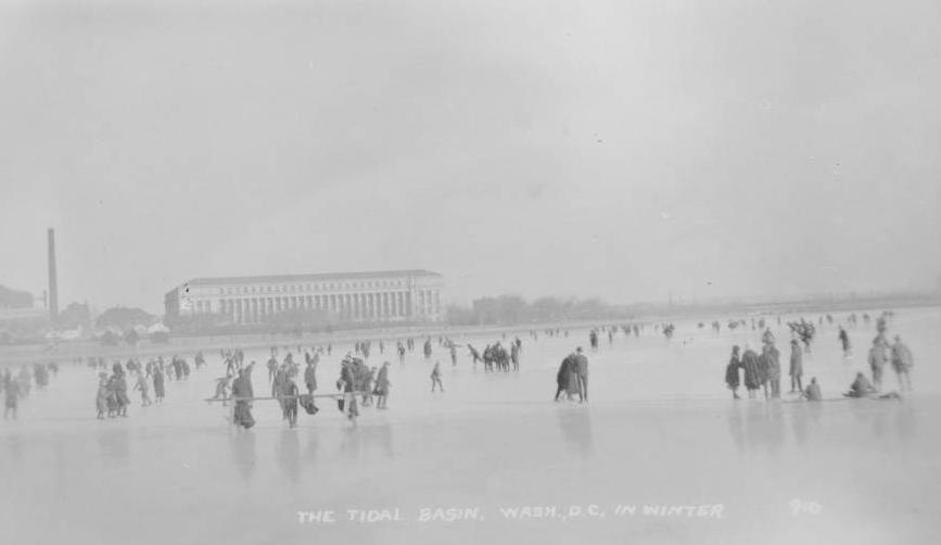 Black and white photo of people ice skating and walking on the Tidal Basin
