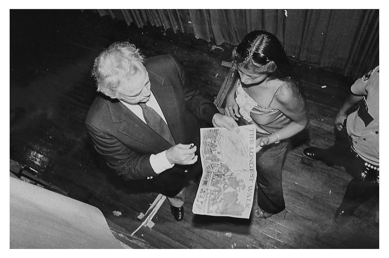 Marlon Brando autographs a poster at the benefit concert. (Reprinted with permission of the DC Public Library, Star Collection © Washington Post.)