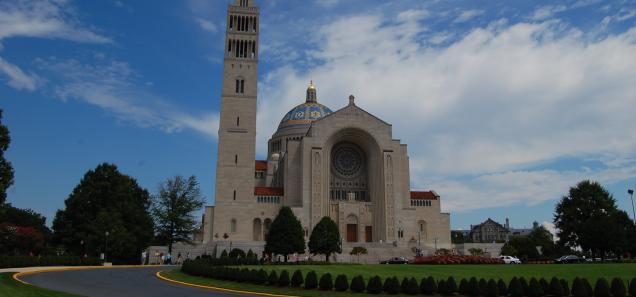 Basilica (Source: Wikipedia) Basilica of the National Shrine of the Immaculate Conception against blue sky.
