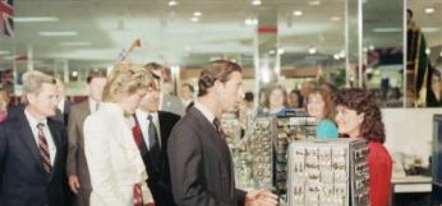 Prince Charles stops to chat with a sales clerk at a costume jewelry display in the Springfield, Va., J.C. Penny store on Nov. 11, 1985. Princess Diana looks at the jewelry. (AP Photo)